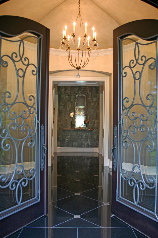 Large victorian vestibule in Chicago with beige walls, a double front door, a glass front door and granite flooring.