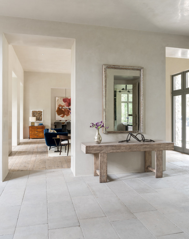 Mid-sized cottage light wood floor entryway photo in Houston with gray walls and a glass front door