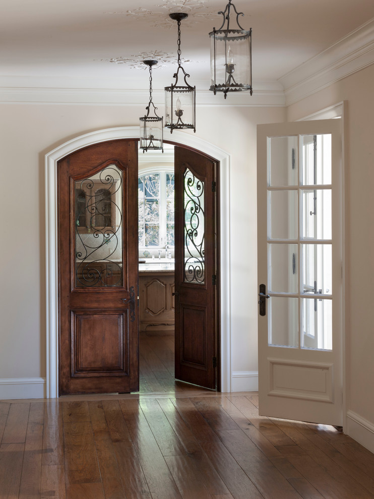 Inspiration for a huge timeless medium tone wood floor entry hall remodel in San Francisco with white walls