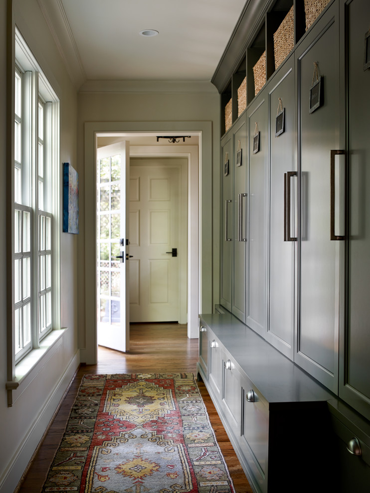 Entryway - mid-sized transitional medium tone wood floor and brown floor entryway idea in Atlanta with beige walls and a glass front door