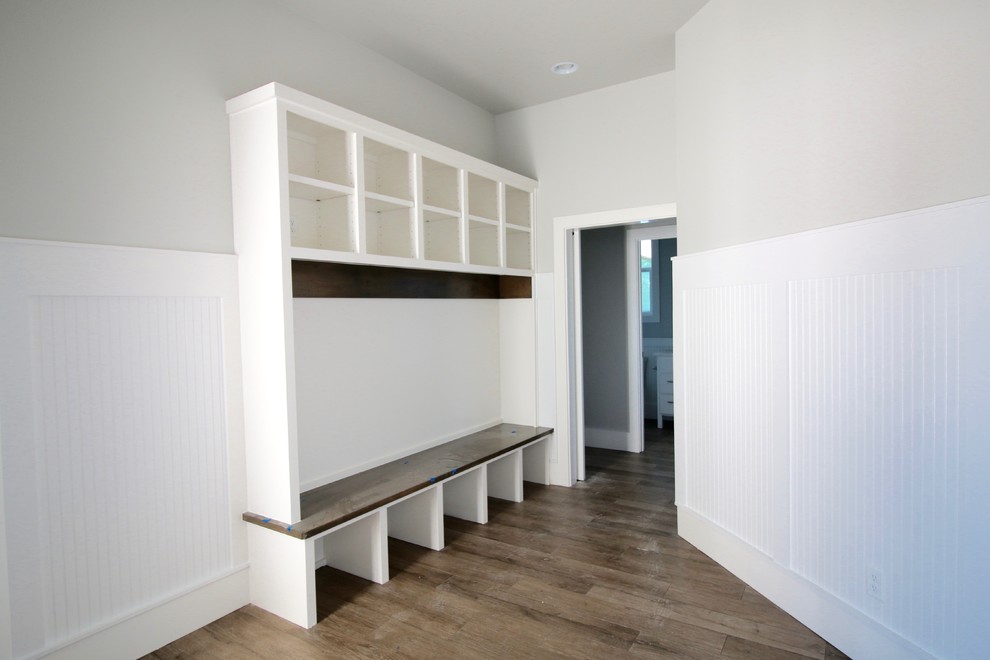 Mudroom - mid-sized farmhouse medium tone wood floor and brown floor mudroom idea in Other with gray walls
