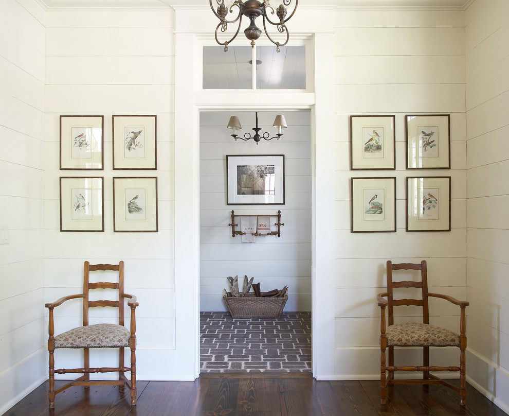 Example of a farmhouse brick floor mudroom design in Atlanta with white walls