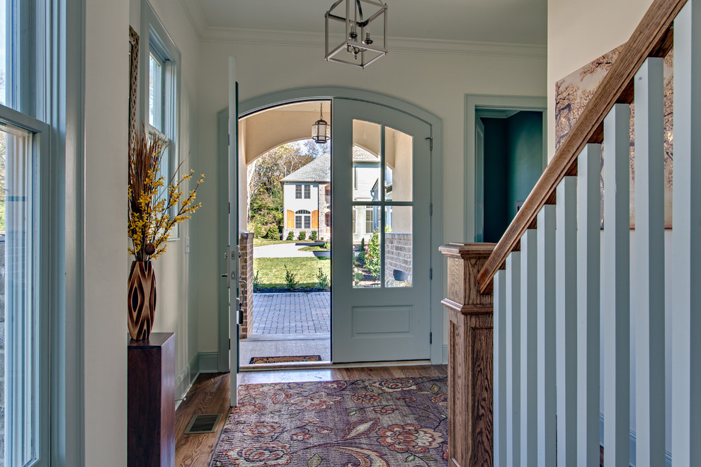 Inspiration for a rustic medium tone wood floor entryway remodel in Nashville with white walls