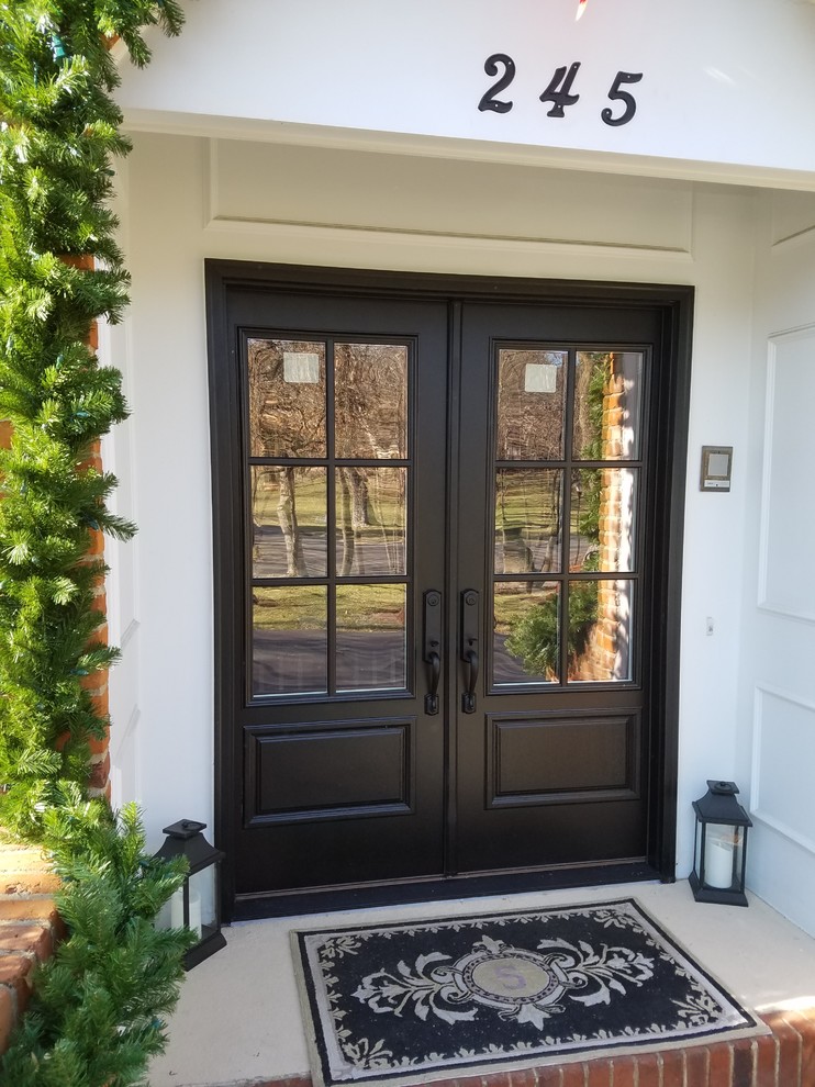 Inspiration for a mediterranean entryway remodel in St Louis with a black front door