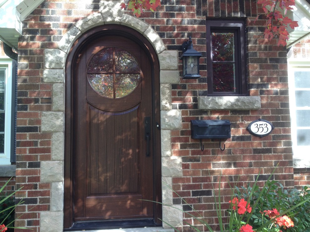 This is an example of a medium sized classic front door in Toronto with a single front door and a dark wood front door.