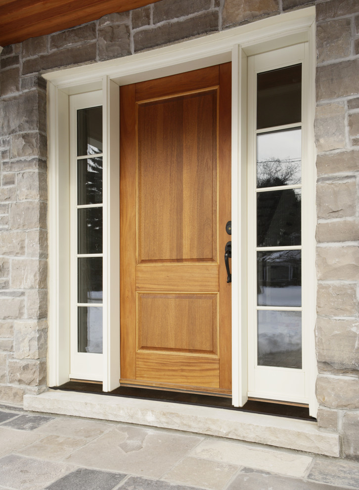 На фото: входная дверь среднего размера в классическом стиле с одностворчатой входной дверью, входной дверью из дерева среднего тона, серыми стенами и полом из сланца