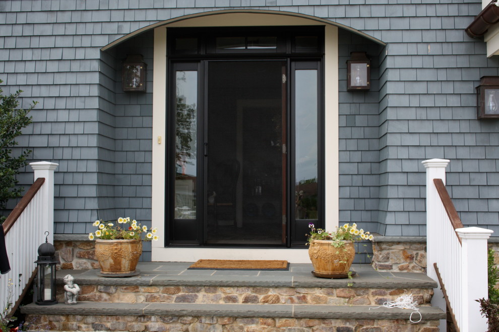 Inspiration for a mid-sized timeless entryway remodel in New York with a black front door