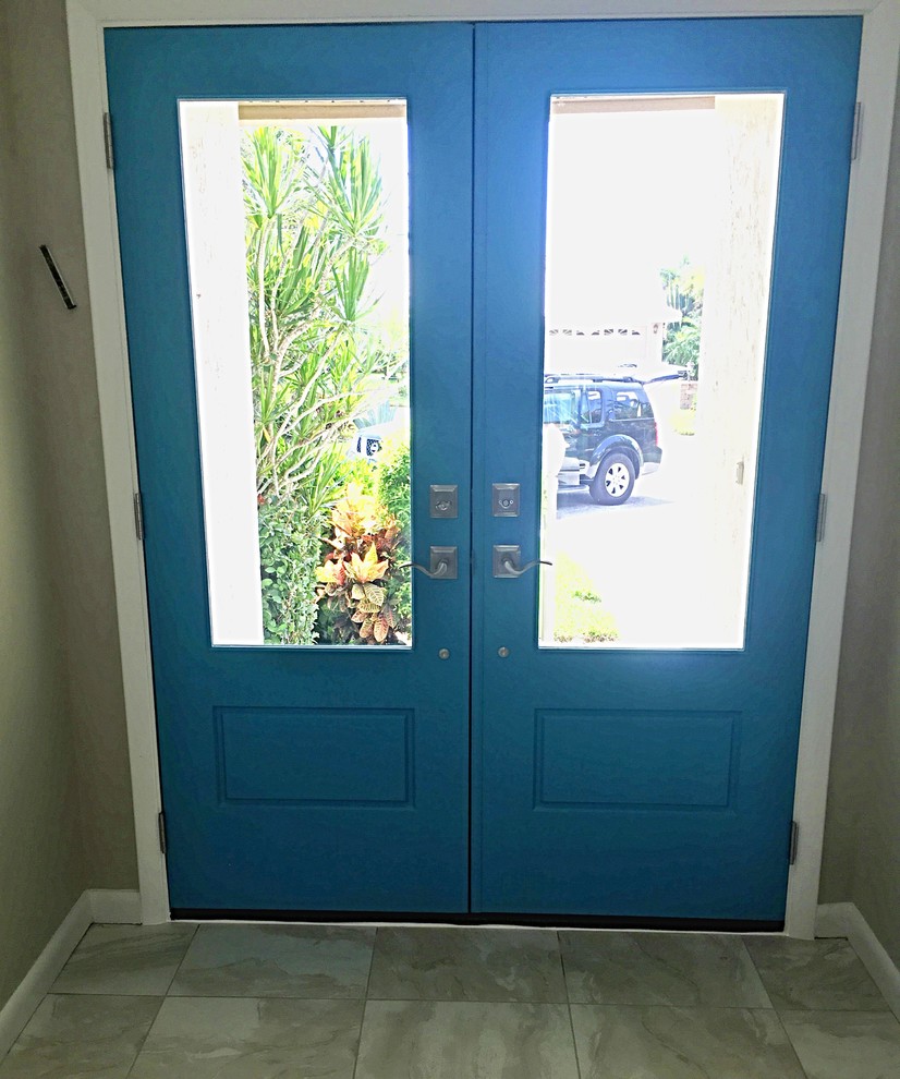 Idée de décoration pour une entrée minimaliste avec une porte double et une porte bleue.
