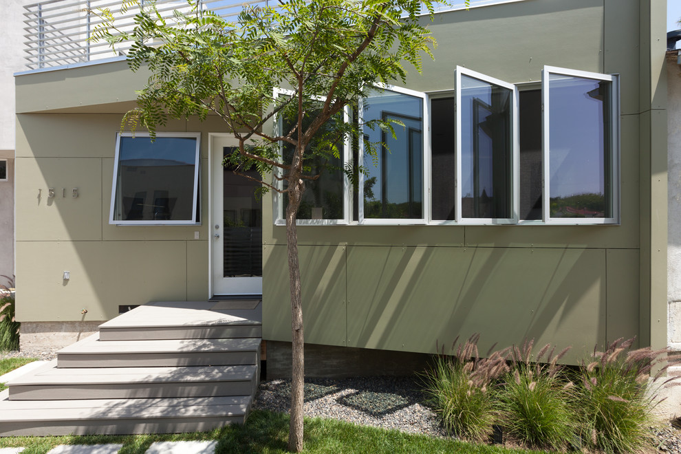 This is an example of a contemporary entrance in Los Angeles with a single front door and a glass front door.