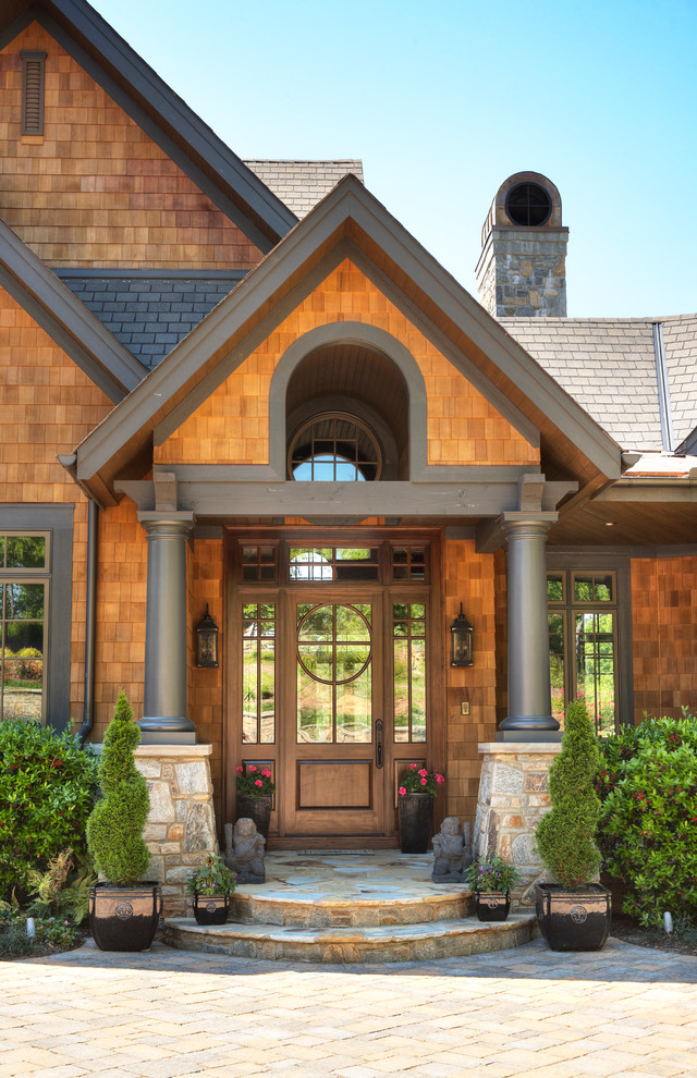 Inspiration for a rustic front door in Other with a single front door, brown walls and a dark wood front door.