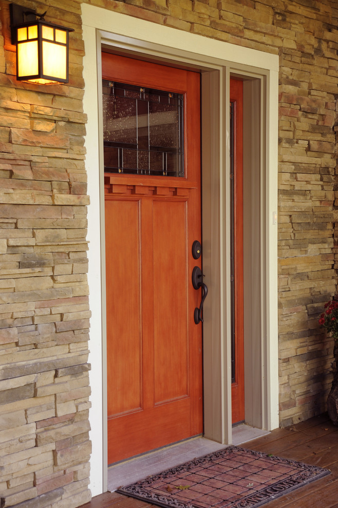 Example of a classic single front door design in Other with a medium wood front door