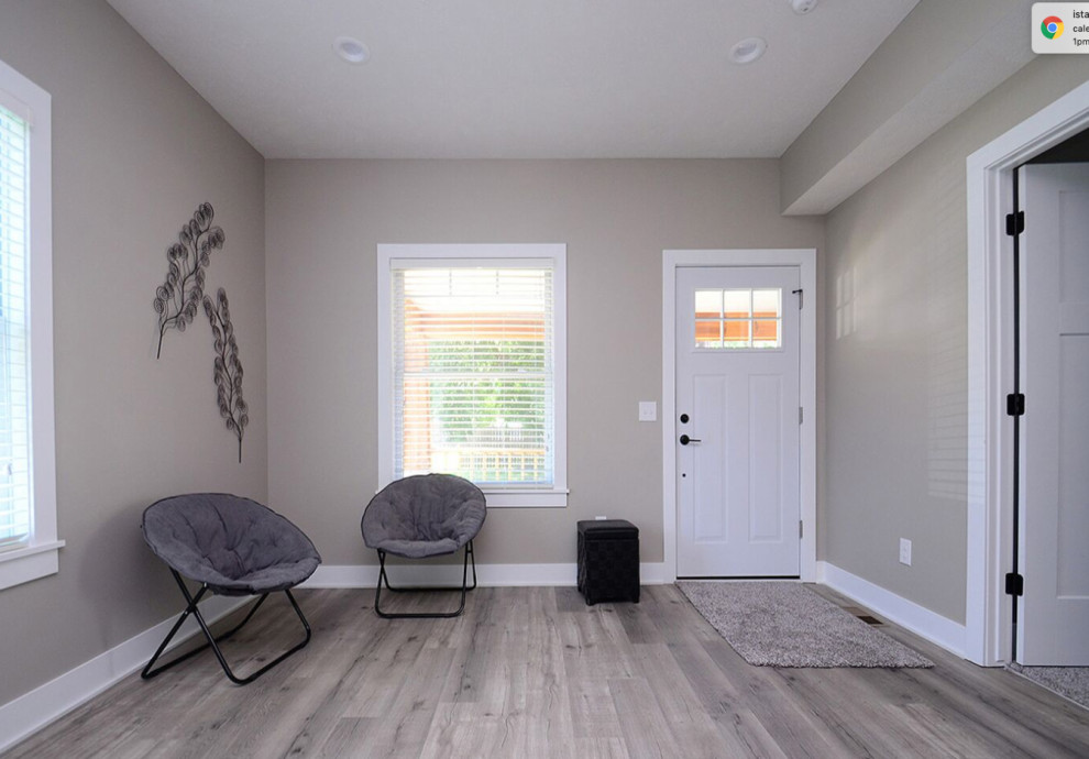 Idées déco pour une petite porte d'entrée moderne avec un mur gris, un sol en vinyl, une porte simple, une porte blanche et un sol gris.