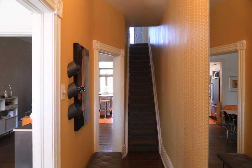 This is an example of a small eclectic foyer in Toronto with yellow walls, ceramic flooring, a single front door and a dark wood front door.