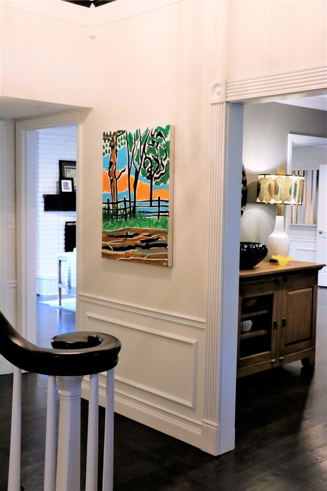 Example of a mid-sized transitional dark wood floor and brown floor foyer design in St Louis with white walls