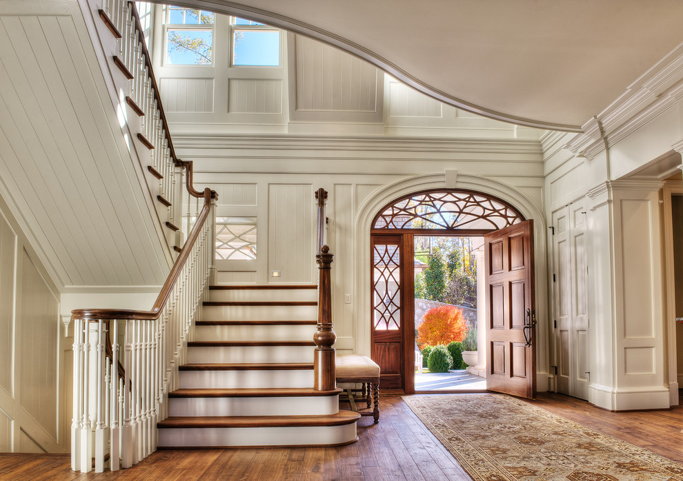 Inspiration for a large classic foyer in Other with white walls, medium hardwood flooring, a single front door and a medium wood front door.