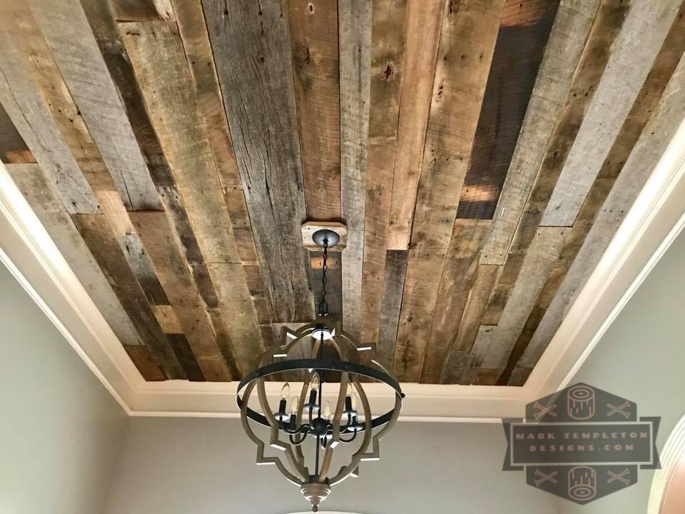This is an example of a medium sized rustic foyer in Nashville with grey walls, light hardwood flooring, a single front door, a glass front door and brown floors.