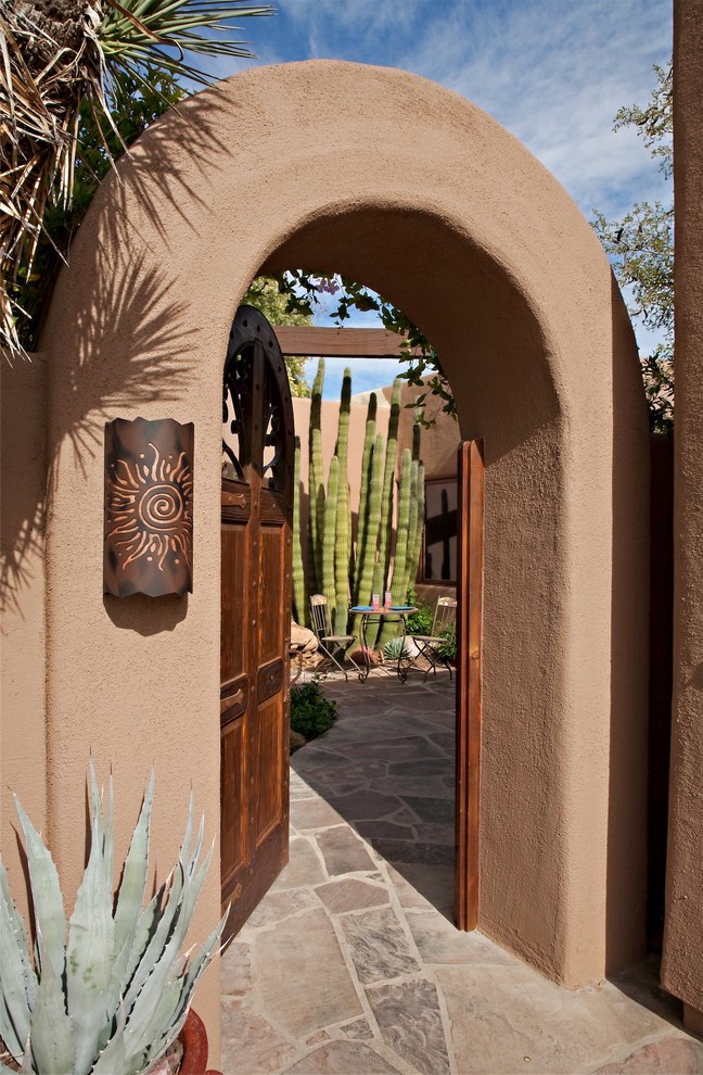 Entrance in Phoenix with a single front door and a dark wood front door.