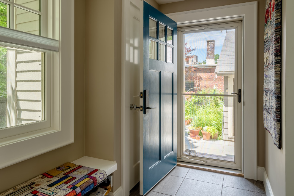 Photo of a small traditional boot room in Boston with beige walls, porcelain flooring, a single front door, a blue front door and grey floors.