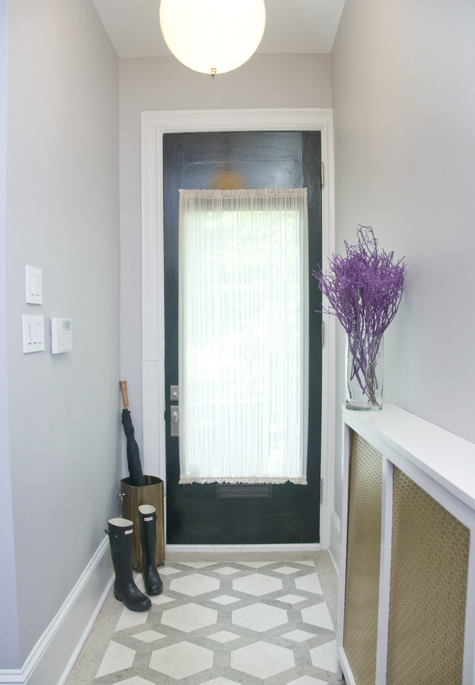 Inspiration for a mid-sized transitional ceramic tile entryway remodel in DC Metro with gray walls