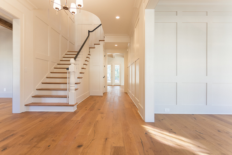 Inspiration for a medium sized traditional hallway in Atlanta with white walls, medium hardwood flooring, a single front door, a medium wood front door and brown floors.