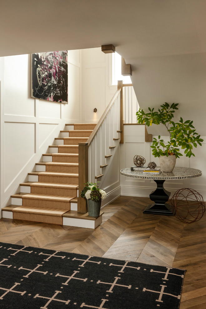 This is an example of an expansive traditional hallway in Philadelphia with beige walls, medium hardwood flooring and brown floors.