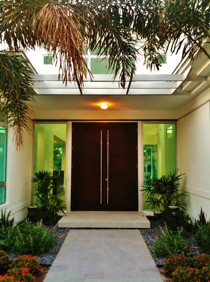 Example of a trendy entryway design in Miami with a black front door