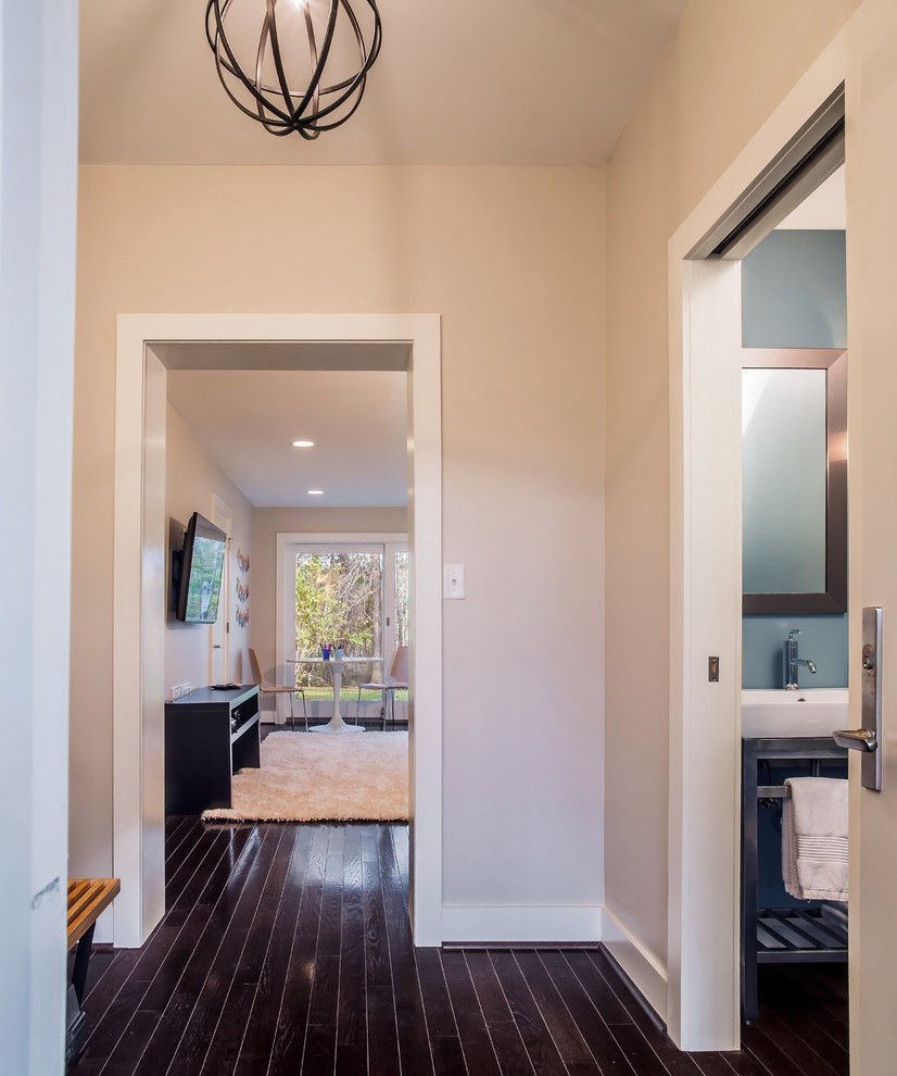 Inspiration for a small 1960s dark wood floor entryway remodel in DC Metro with beige walls and a white front door