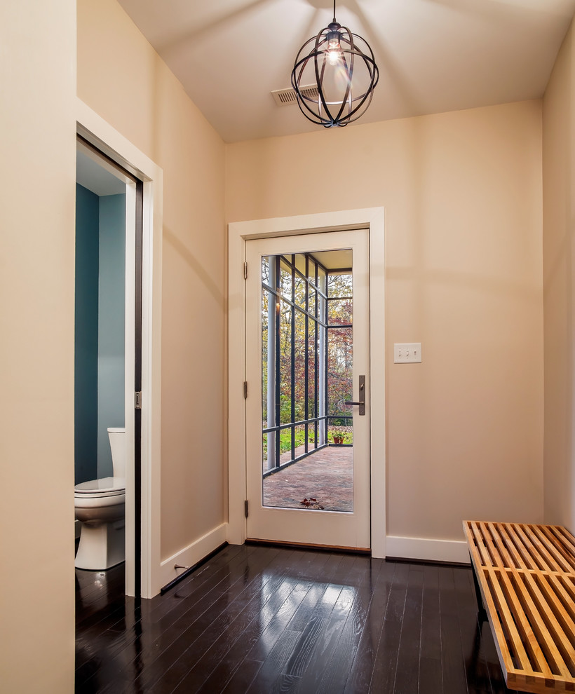Inspiration for a small 1950s dark wood floor entryway remodel in DC Metro with beige walls and a white front door