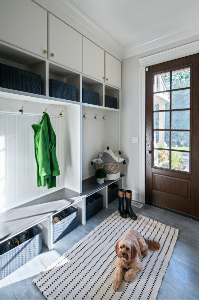 This is an example of a medium sized traditional boot room in Chicago with grey walls, porcelain flooring, a single front door, a dark wood front door and grey floors.