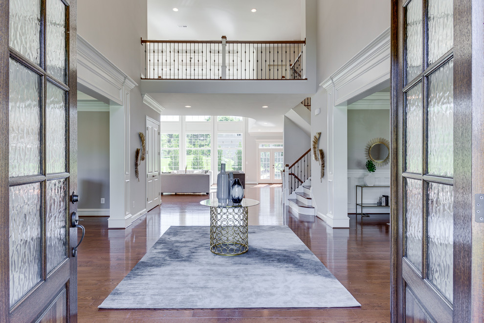 Photo of an expansive traditional foyer in DC Metro with grey walls, medium hardwood flooring, a double front door and a dark wood front door.