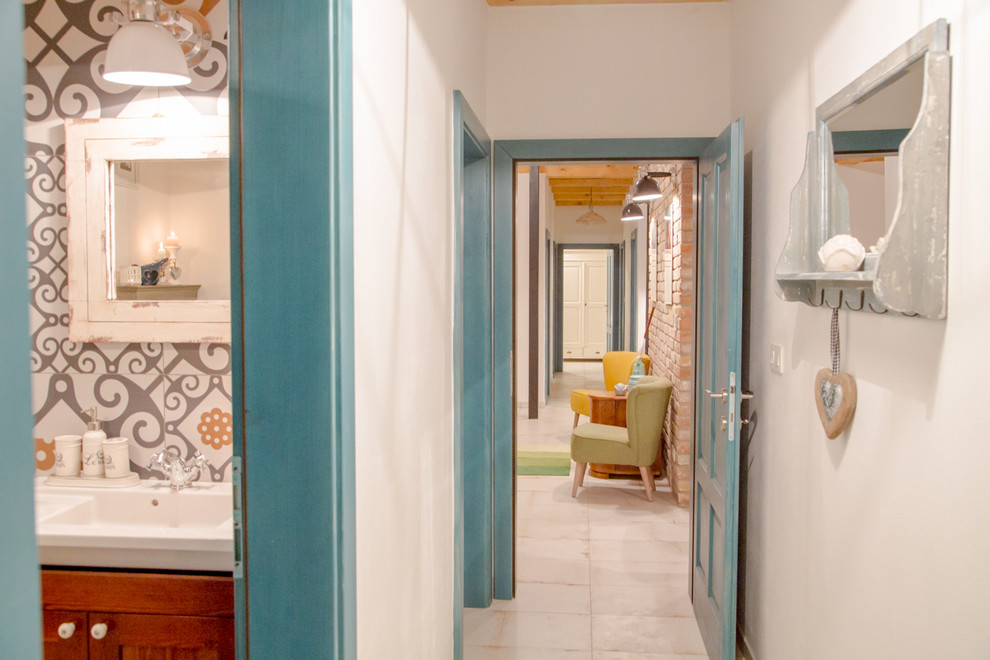 他の地域にあるお手頃価格の小さなカントリー風のおしゃれな玄関 (白い壁、セラミックタイルの床、青いドア) の写真