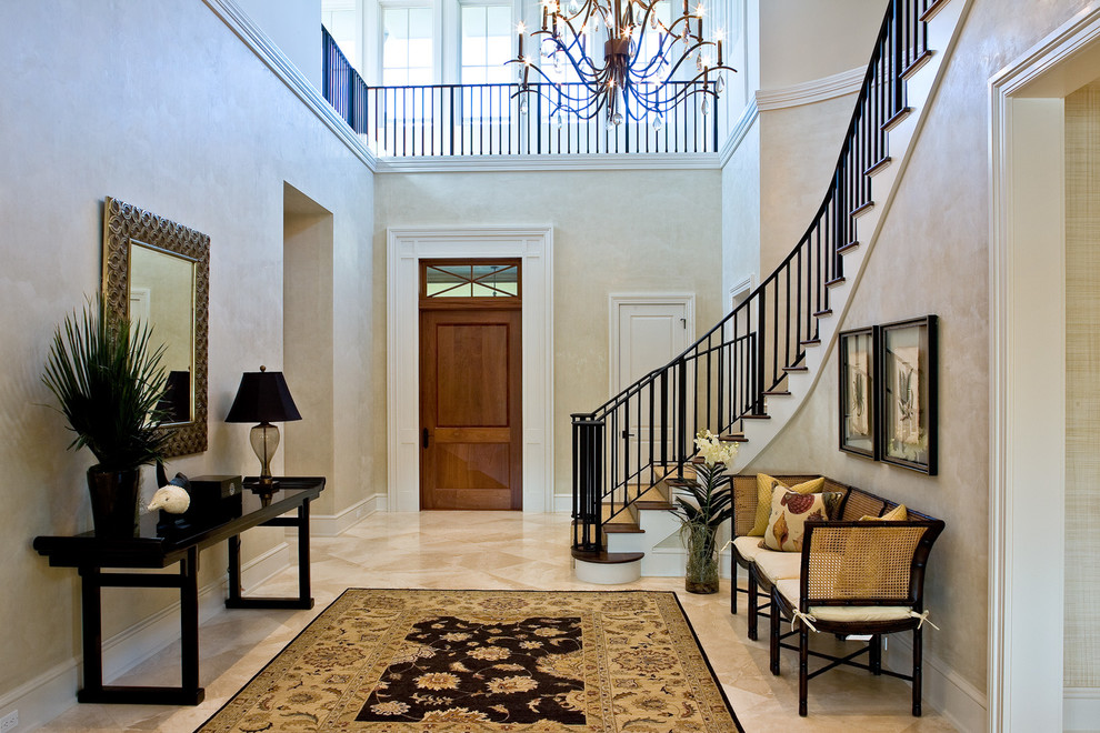 Inspiration for a large transitional travertine floor entryway remodel in Miami with beige walls and a medium wood front door