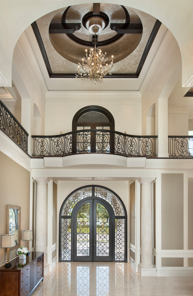 Inspiration for an expansive classic foyer in Miami with beige walls, marble flooring, a double front door, a metal front door and feature lighting.
