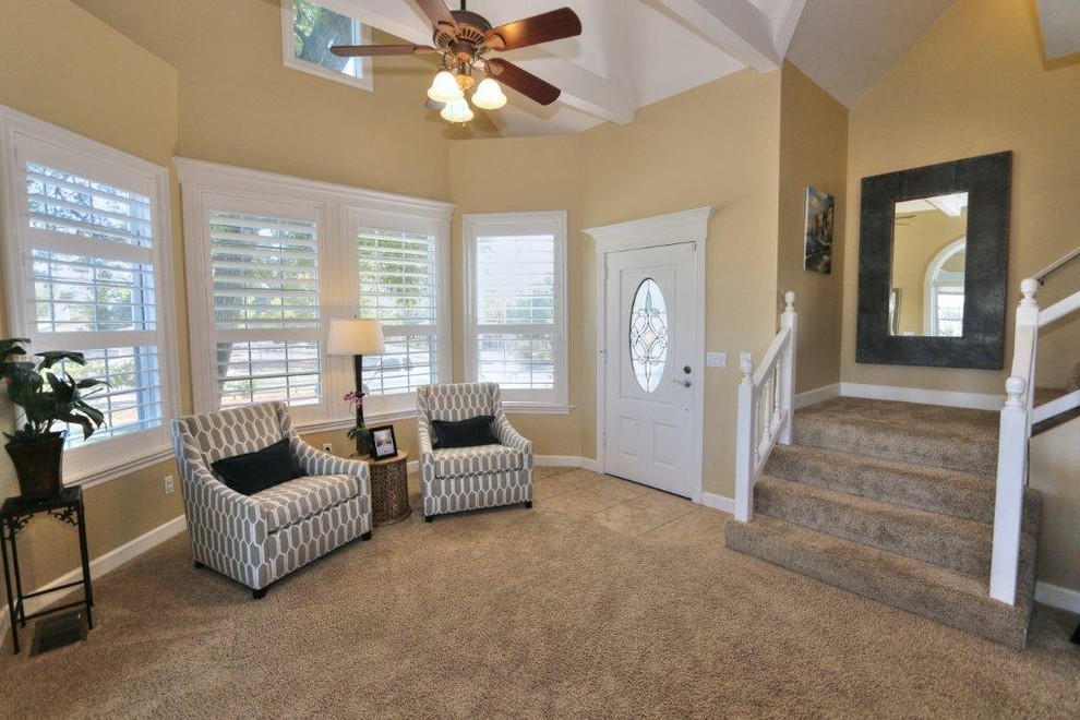 Entryway - small carpeted entryway idea in Sacramento with beige walls and a white front door