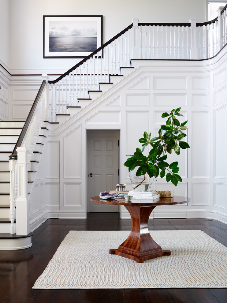 Photo of a coastal foyer in Jacksonville with white walls and dark hardwood flooring.