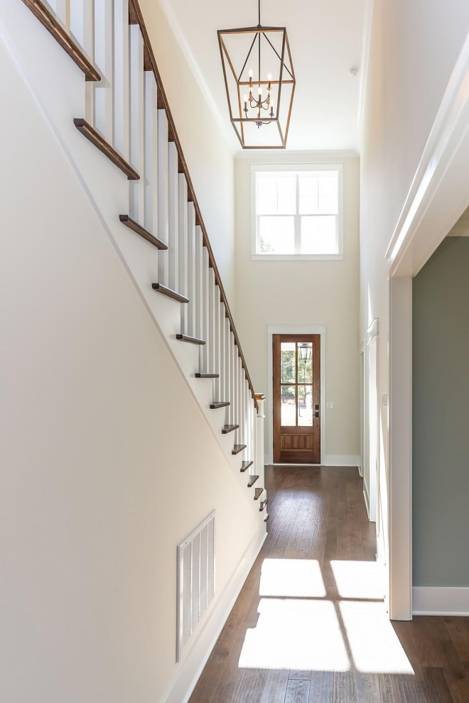 Traditional foyer in Raleigh with white walls, medium hardwood flooring, a single front door, a medium wood front door and brown floors.