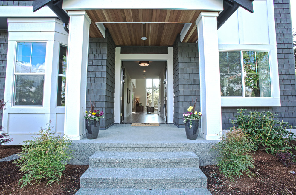 Example of a large arts and crafts entryway design in Seattle with a black front door