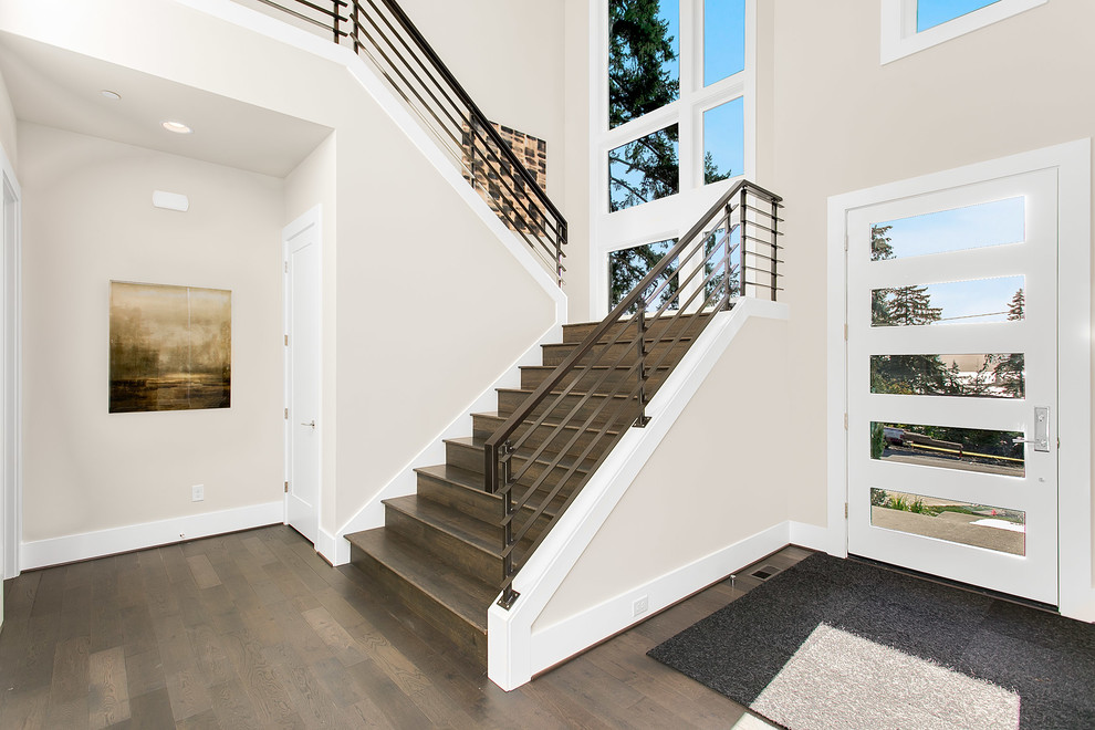 Inspiration for a large modern foyer in Seattle with grey walls, medium hardwood flooring, a single front door and a white front door.