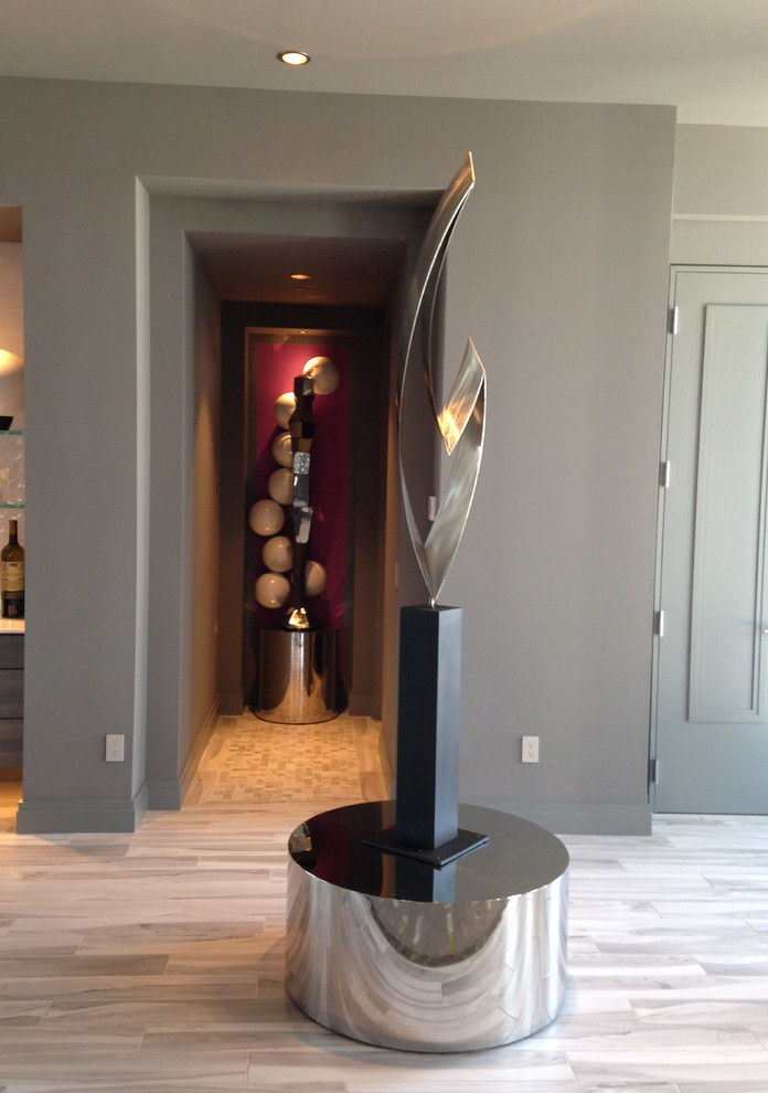 Photo of an expansive contemporary foyer in Denver with grey walls and ceramic flooring.