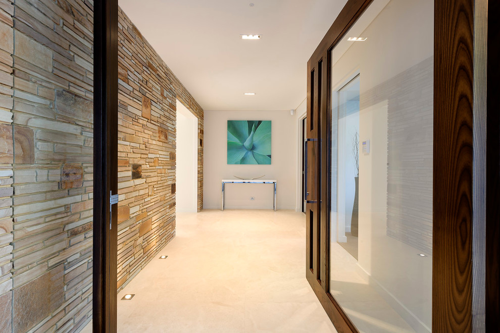 Photo of a medium sized modern foyer in Perth with multi-coloured walls, limestone flooring, a pivot front door and a glass front door.
