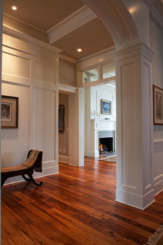 Large elegant medium tone wood floor entry hall photo in Charleston with white walls