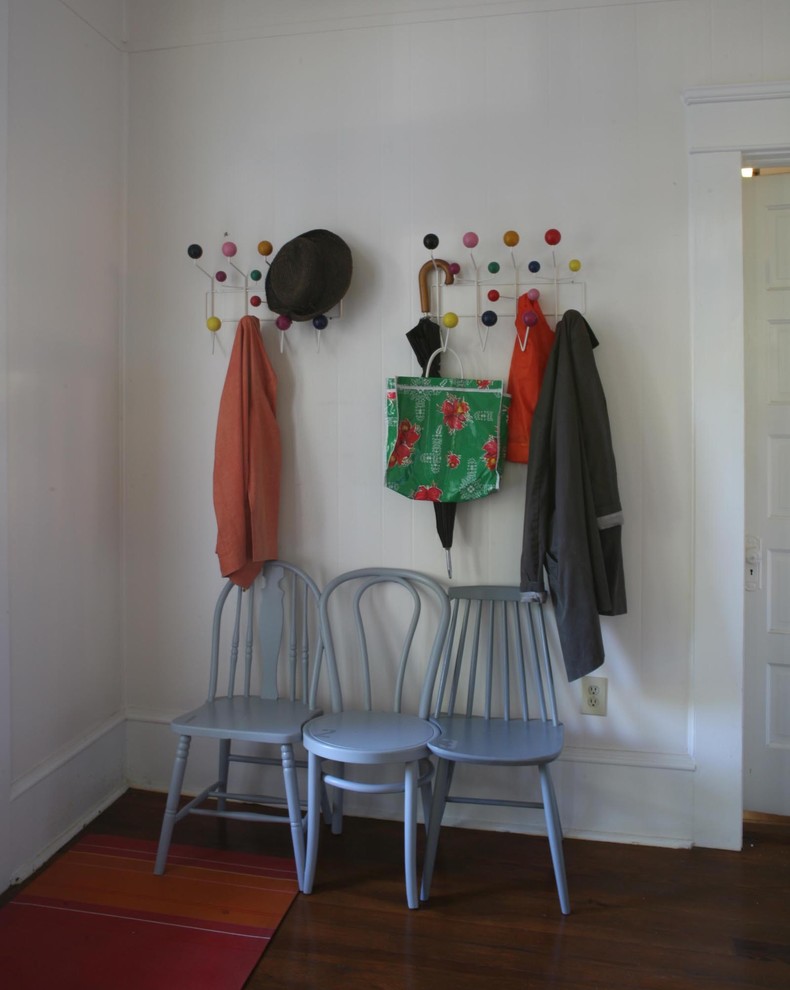 Eclectic entryway photo in New York with white walls