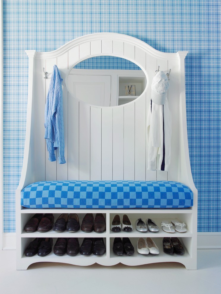 This is an example of a beach style boot room in New York with blue walls.