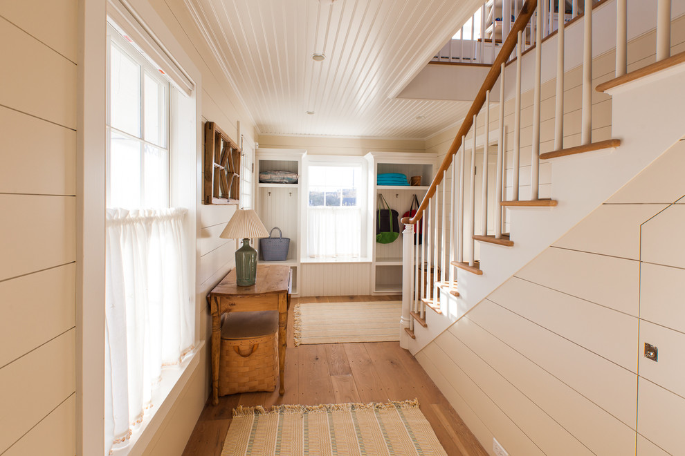 Design ideas for a medium sized nautical hallway in Boston with white walls, medium hardwood flooring, a stable front door and a white front door.