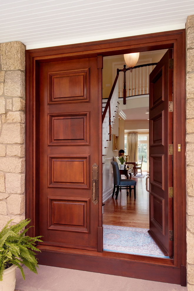 This is an example of a traditional entrance in New York with a double front door and a dark wood front door.