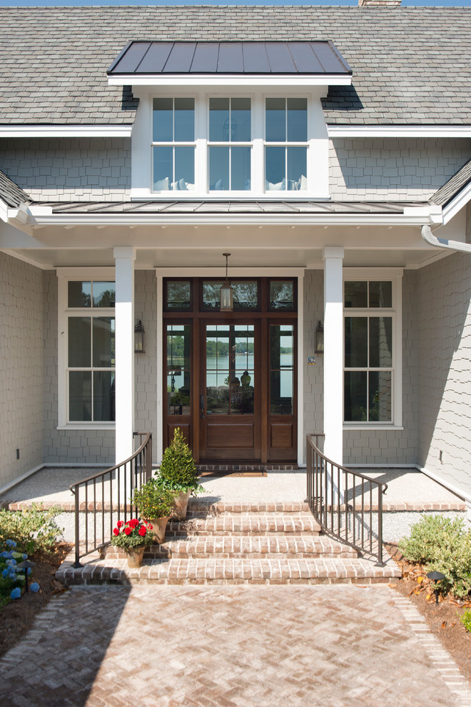 This is an example of a large classic front door in Atlanta with green walls, brick flooring, a single front door, a dark wood front door and red floors.