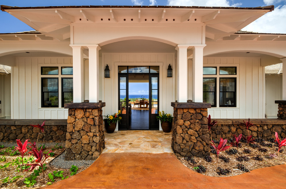 Medium sized modern front door in Hawaii with white walls, slate flooring, a single front door, a glass front door and black floors.
