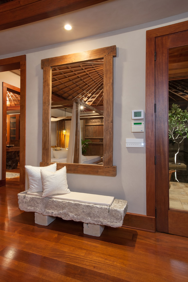Entry hall - mid-sized tropical medium tone wood floor entry hall idea in Hawaii with white walls