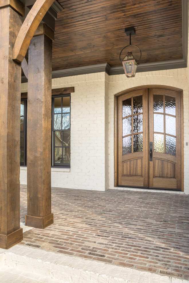 Large elegant entryway photo in Other with white walls and a dark wood front door