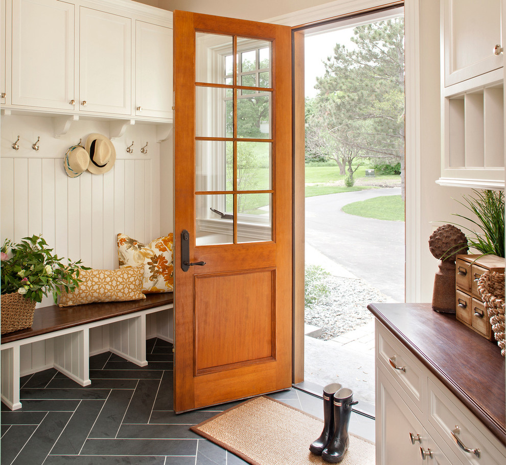 Example of a mid-sized classic slate floor entryway design in Minneapolis with beige walls and a medium wood front door